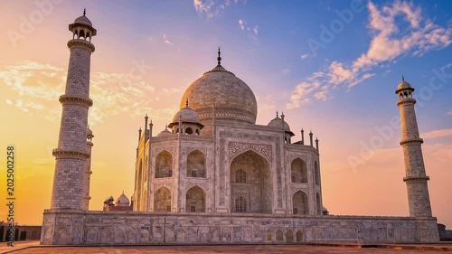 Taj Mahal mausoleum at sunrise with dramatic clouds