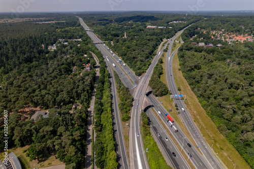 Aerial of A28 freeway in Dutch moorland sand landscape of Leusden near Amersfoort. Traffic and artery interstate seen from above.