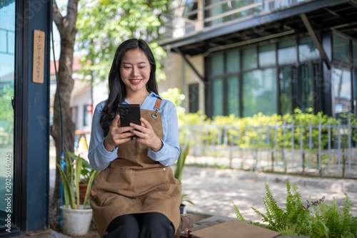 Young woman enjoying coffee outdoors while using smartphone app