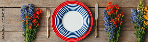 Patriotic table setting plate fork knife wildflower red white blue dinner scene for 4th of july celebration rustic wooden table with bright
