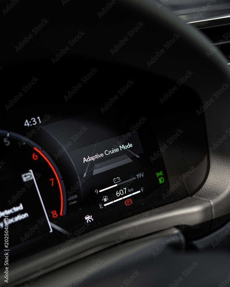 Obraz premium Close Up View of Car Dashboard Instrument Cluster at Night.