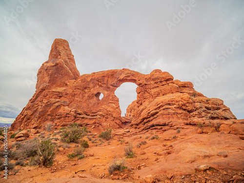 Schilderij op canvas Turret Arch and North Window frame the desert landscape.