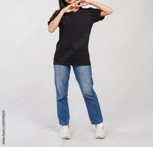 Faceless Asian woman body wearing black t-shirt and blue jeans isolated on white background