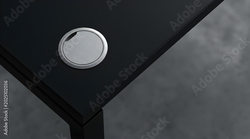 Minimalist black office desk corner with single white object on brushed aluminum surface