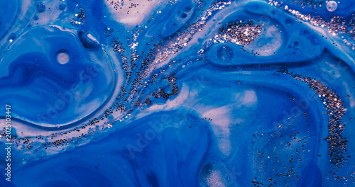 Blue paint water. Sequins background. Blur color pigment in acrylic marble glitter fluid round texture flowing on creative art abstraction.