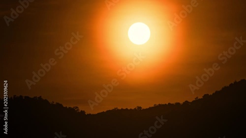 Mountain sunset time-lapse with flowing mist and golden hour light hitting the ridges.