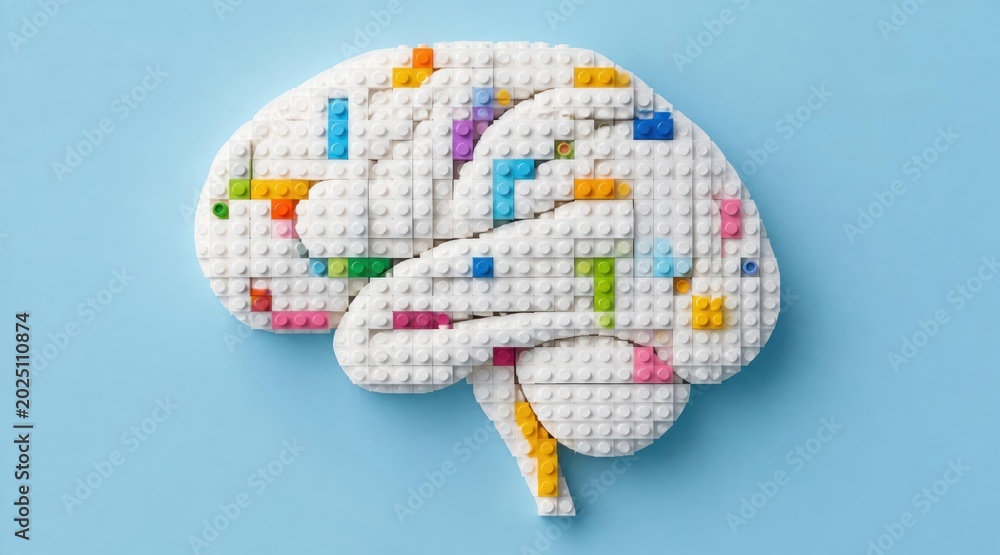 Naklejka premium Brain made of white Lego bricks with colorful building blocks, symbolizing intelligence, creativity, and learning. Isolated on a light blue background, top view.