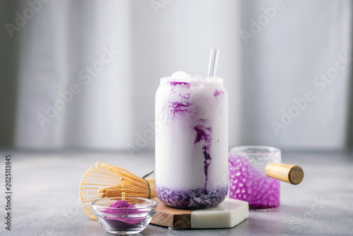Ube latte in glass. Healthy vegan drink. Viral trendy asian beverage