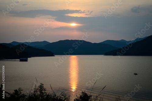 Mountain views and a summer sunset at Mae Kuang Udom Thara Dam, Chiang Mai Province, Northern Thailand.