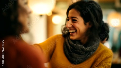 Woman laughing joyfully in a cozy caf? setting