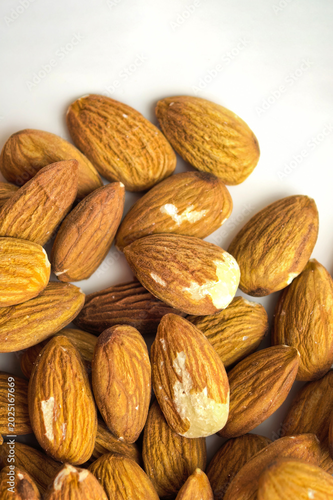 Fototapeta premium Raw almonds filling the frame in a detailed close up composition. Healthy natural snack ingredient with visible nut texture