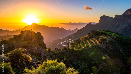 A serene mountainous landscape at sunset with lush greenery and a vibrant sky
