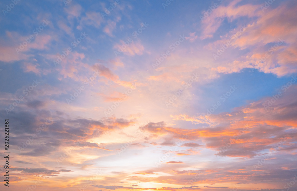 Fototapeta premium Soft pastel clouds glow with sunset's warmth