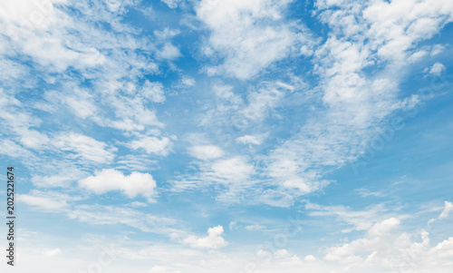 Canvas Print Soft clouds drift across vast, serene blue skies