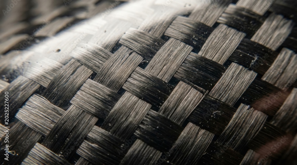 © Nuttawut - Carbon Fiber Texture: A close-up, macro view reveals the intricate woven pattern of carbon fiber material, showcasing its unique texture and strength. © Nuttawut - Carbon Fiber Texture: A close-up, macro view reveals the intricate woven pattern of carbon fiber material, showcasing its unique texture and strength.