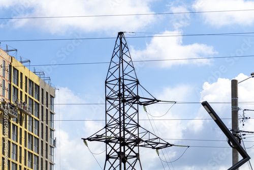 Принти на полотні Electricity Tower Stands Against the Sky With Clouds Near a Construction Site Sh