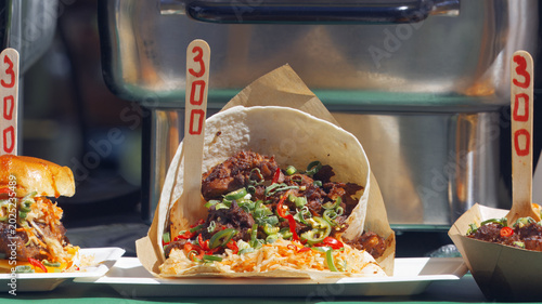 Tableau sur toile Delicious Jamaican jerk chicken wrapped in flatbread with rice, salad, and fresh chilies