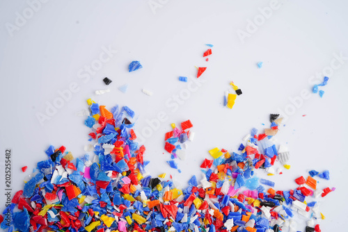 Photos Plastic colorful pieces recycling shredded for industrial use.