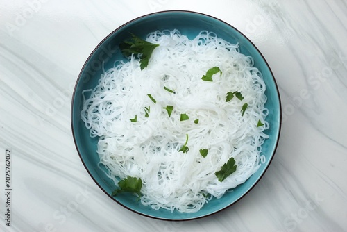 Fényképezés top view of a plate of rice noodles with celery sprinkled on top