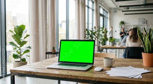 Ultra realistic modern office workspace with a laptop displaying a bright green chroma key screen on a wooden desk, clean minimalist office interior, soft natural daylight coming through large windows