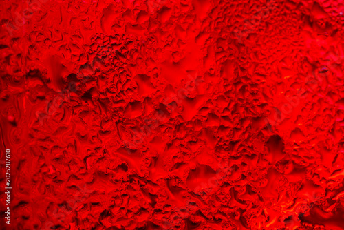 Bilde på lerret Abstract macro background of refreshing cold red soda drink with water drops and bubbles,A close-up macro shot of a vibrant red carbonated beverage texture