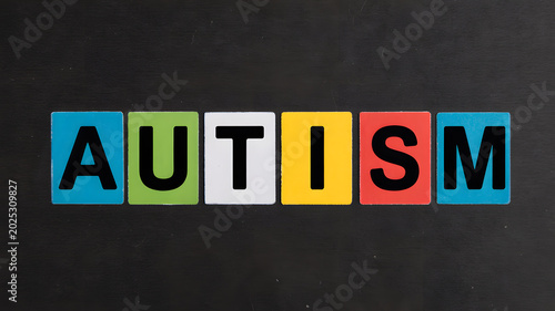 A colorful representation of the word autism on a black background