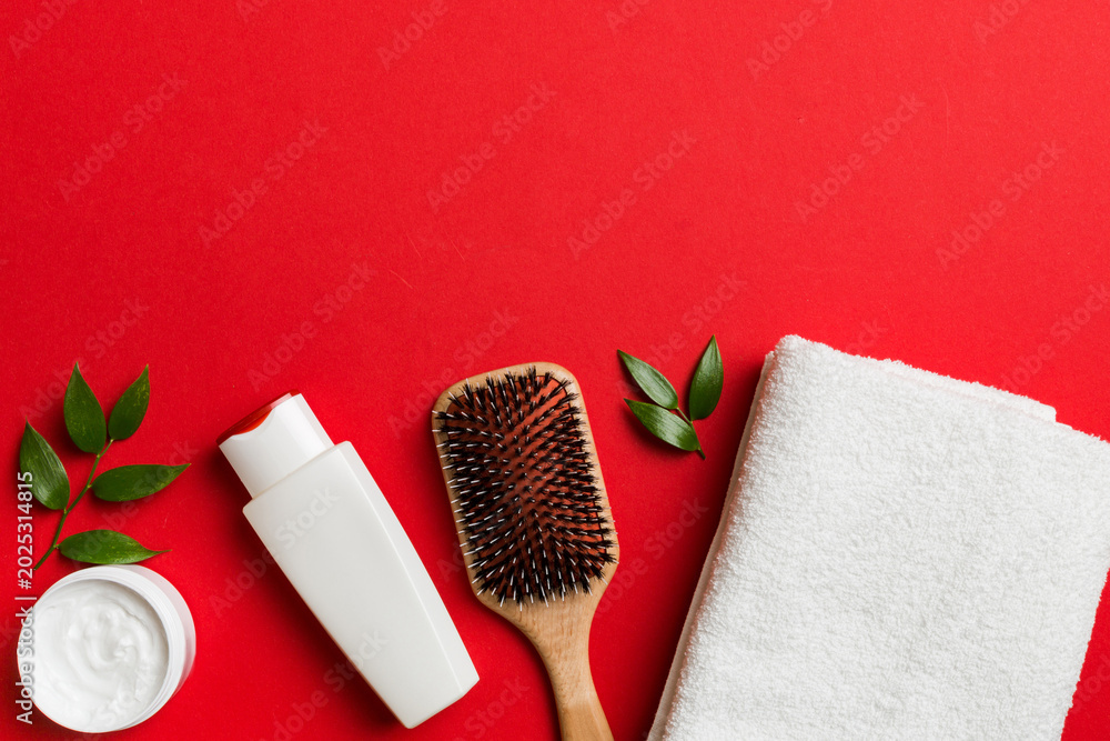 Fototapeta premium cosmetic for hair care, cream and towel on a colored background top view. flat lay