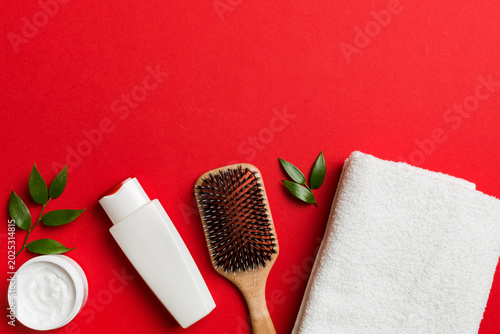 cosmetic for hair care, cream and towel on a colored background top view. flat lay