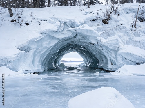 Natural Ice Cave Arch Formed on a Frozen Winter Lake