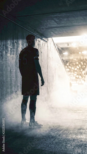 Silhouette of a Professional Soccer Player in Stadium Tunnel Before Match