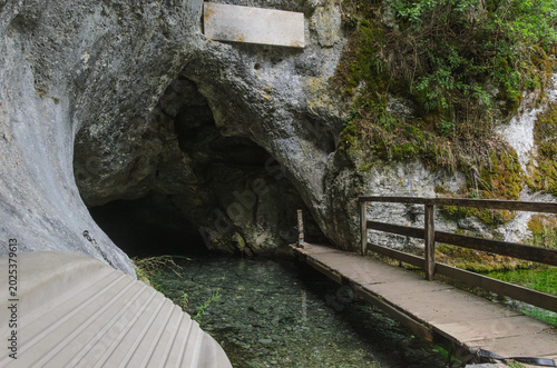 Mysterious Cave Entrance With Wooden Walkway