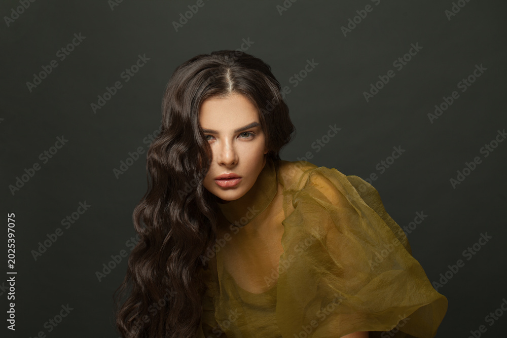 © millaf (Nemchinova) - Posing brunette woman with long healthy hair on dark background © millaf (Nemchinova) - Posing brunette woman with long healthy hair on dark background