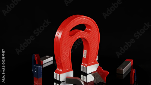Schilderij op canvas Red Horseshoe Magnet and Various Small Magnets on Reflective Black Surface