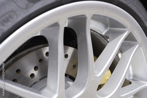 Photos Drilled Brake Disc Behind Alloy Car Wheel Close Up