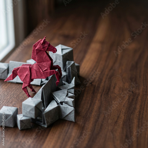 Origami horse paper sculpture ai agent for business creative concept on wooden table