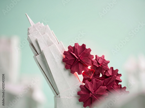 Paper flower craft with ai agent for business decor in white vase against pastel background