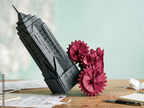 Paper model of business building and gear on desk for ai agent