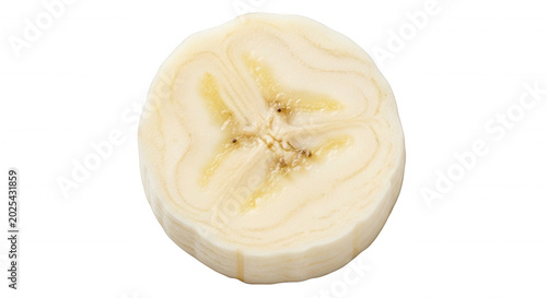 A single, round slice of fresh banana showing the internal texture and seeds, isolated against a solid black background