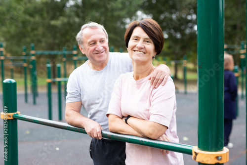 Fényképezés Elderly man and woman posing in open-air sports bars complex