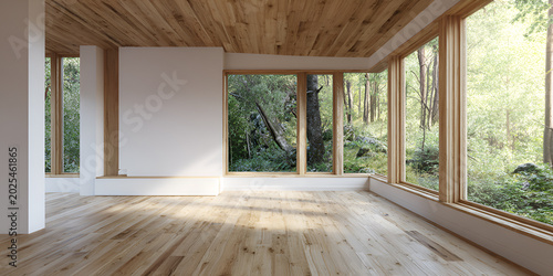 Modern interior with wooden floors, ceiling, and window frames. Large windows offer a view of a lush green forest, bright sunlight