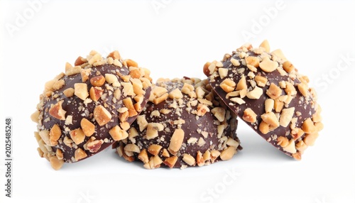 Chocolate covered treats with nuts are arranged on a white surface