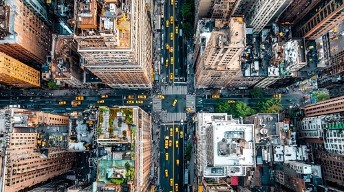 Aerial bird's eye view of New York downtown rooftops, traffic cars and yellow cabs on city streets, wide helicopter cityscape background