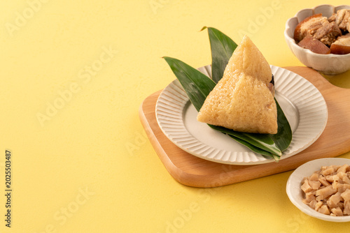 Traditional Chinese sticky rice dumpling Zongzi with side ingredients.