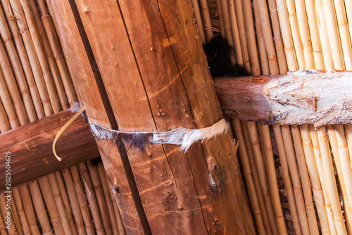 A traditional wooden structure bound with animal hide stands