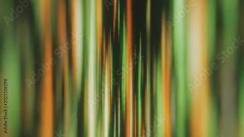 Abstract vertical lines moving in the style of a speed tunnel with green, orange and white colors