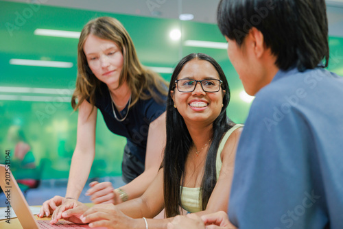 Young Business Team Collaborating with Laptops in Modern Workspace