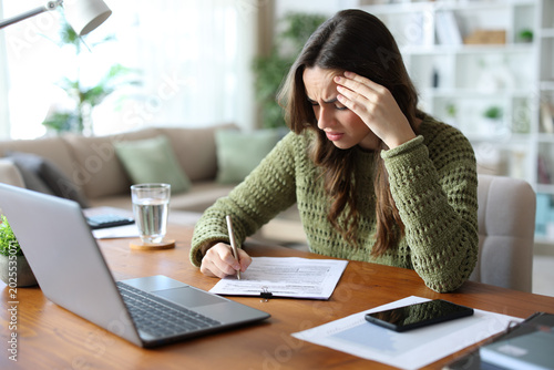 Worried teleworker filling out form or doint test