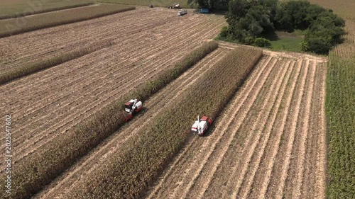 Combine harvester is working in the field from an aerial view. Combine harvester is harvesting ripe wheat in the field.(VDO4K)	