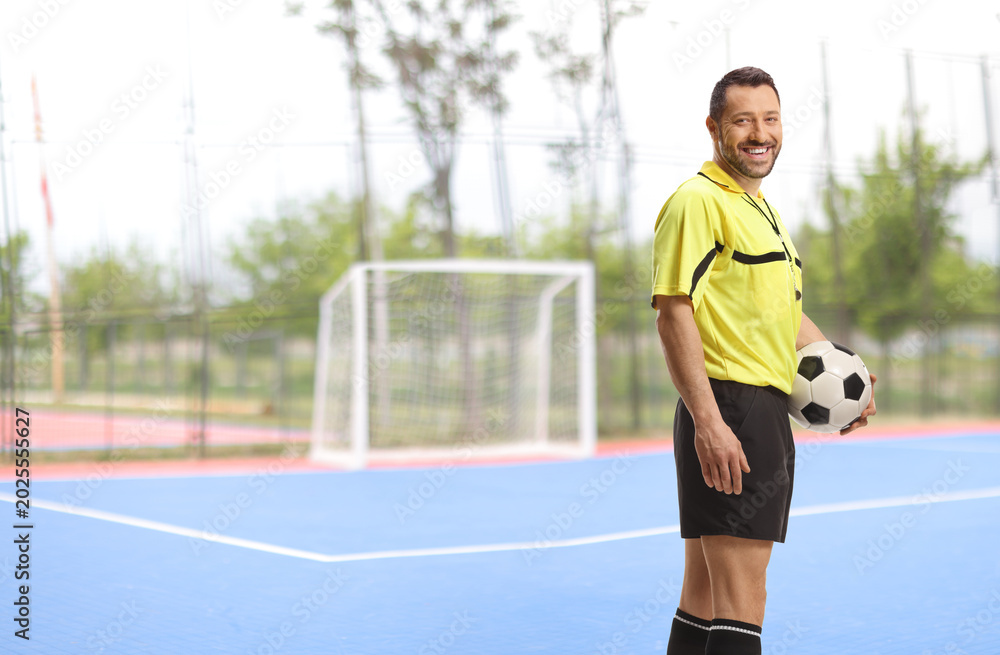 Obraz premium Football referee holding a ball