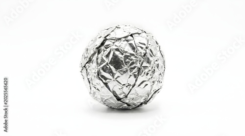 crumpled ball of silver aluminum foil is centered in the frame against a stark white background